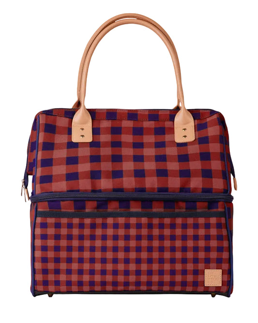 A structured tote bag with a red and navy blue buffalo plaid pattern, featuring tan leather handles and trim, set against a light gray background.