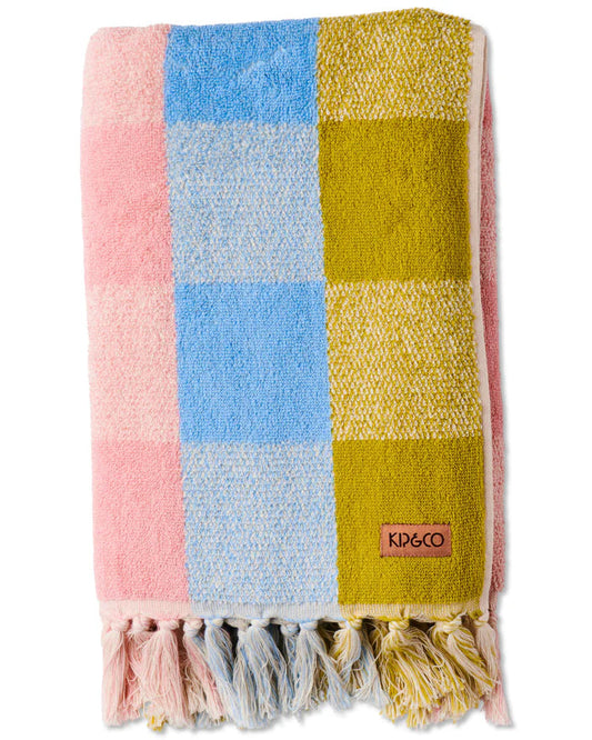 Colorful checkered towel with tassels and a brand logo on a white background