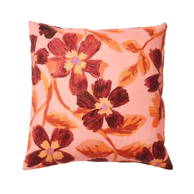 Floral-patterned pillow with red flowers on a pink background