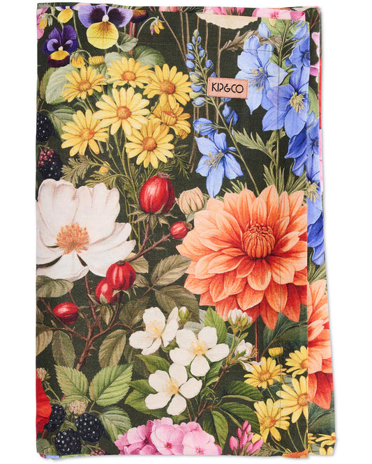 Floral patterned tablecloth with 'Kip & Co' branding on a white background