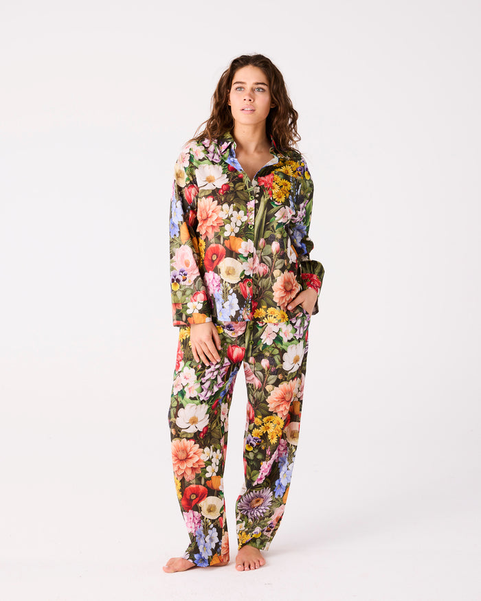 Person wearing a floral pyjama set on a white background
