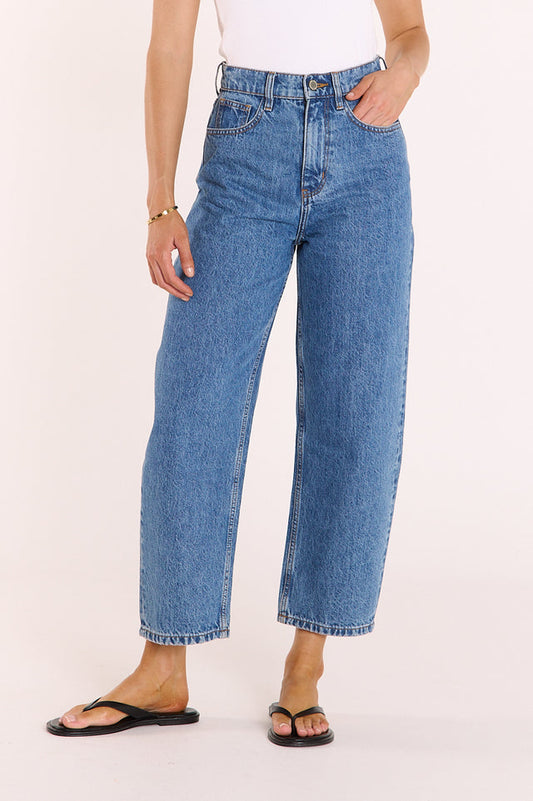 Person wearing blue jeans on a white background
