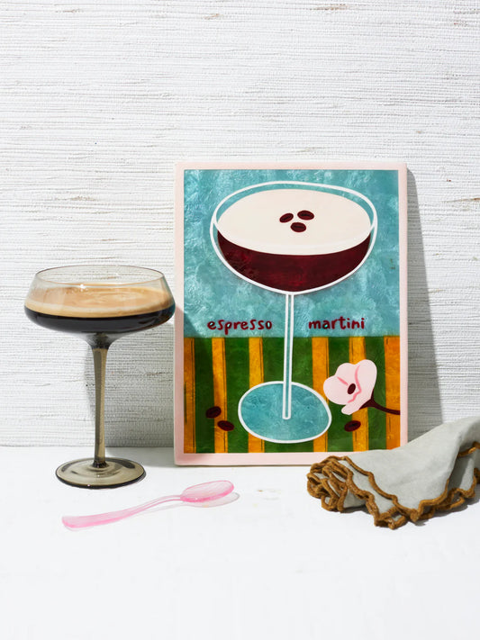 Art print of an espresso martini with a glass and spoon on a white surface.
