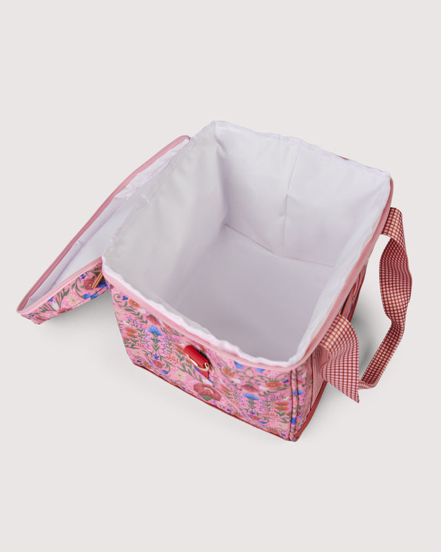 Pink floral picnic bag with a white interior on a light gray background