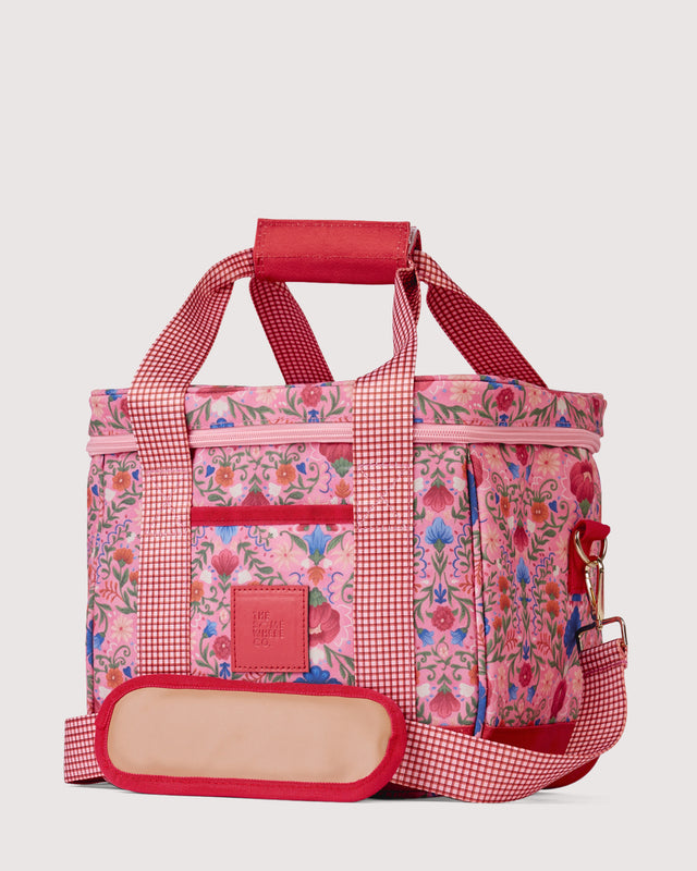 Floral-patterned cooler bag with red accents on a light gray background
