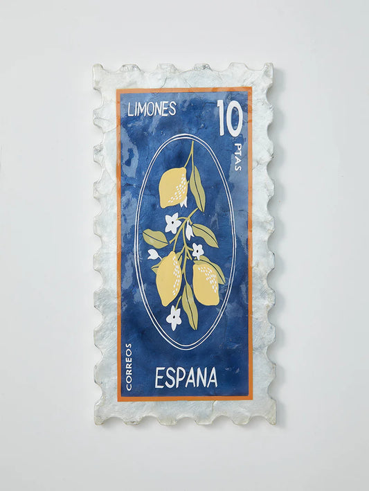 Decorative wall art resembling a Spanish stamp with lemons and flowers on a blue background.