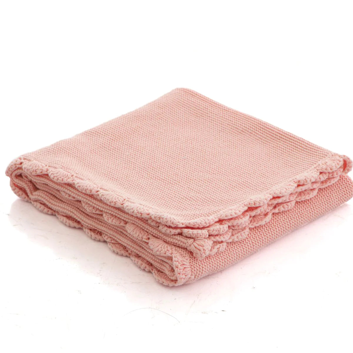 Folded pink blanket on a white background