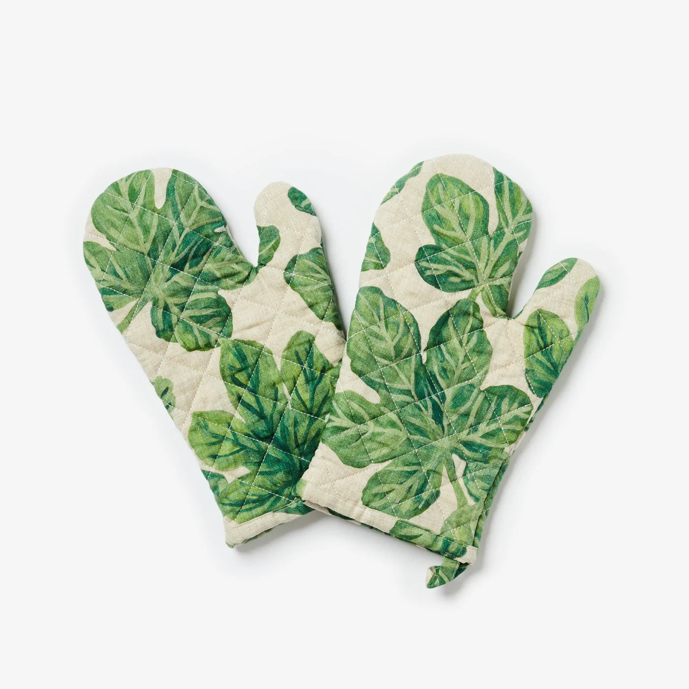 Pair of green leaf-patterned oven mitts on a white background