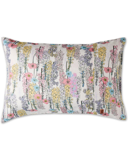 A linen pillowcase with a white background featuring a floral pattern with illustrated foxglove flowers in soft pastel tones.