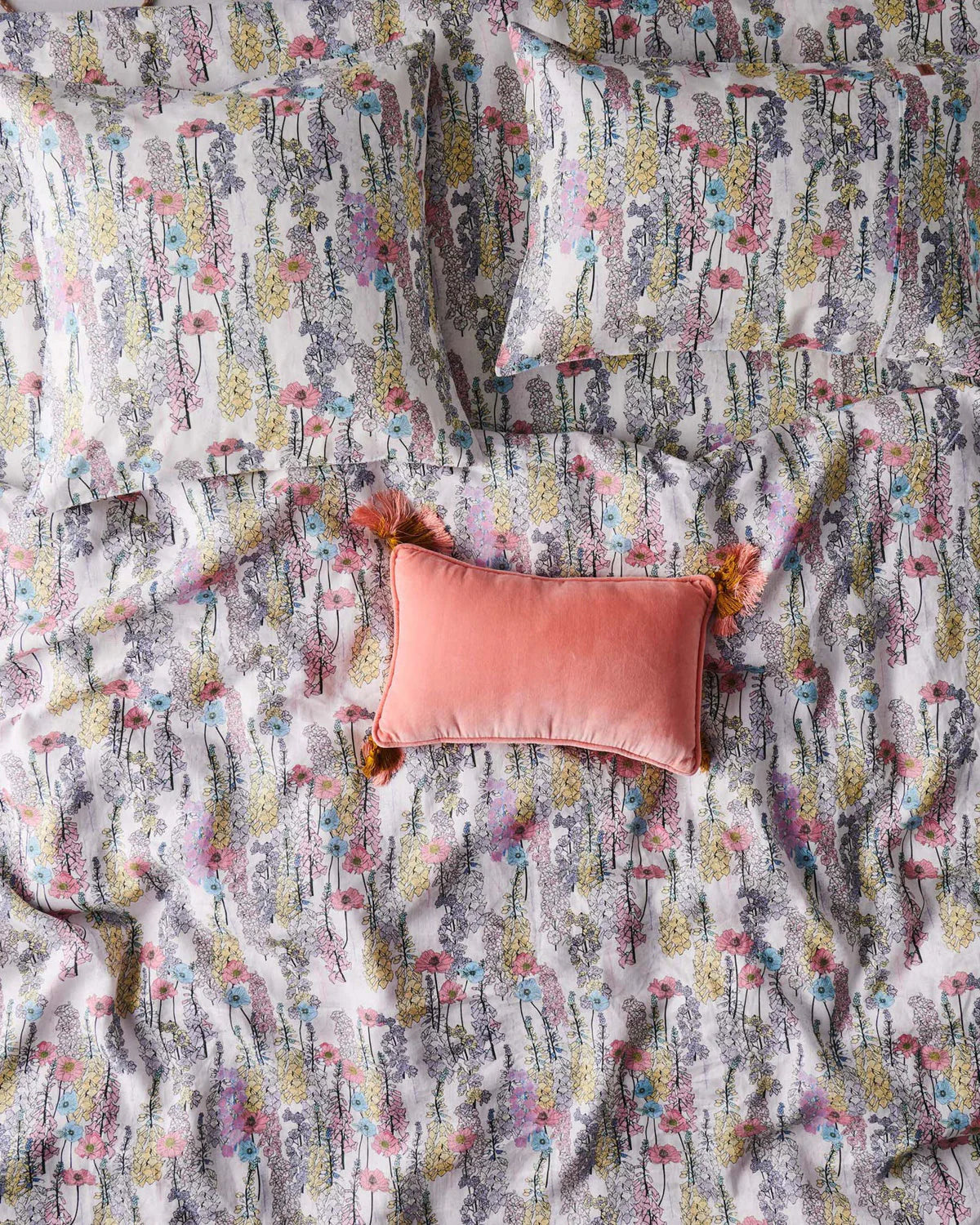 Patterned fabric with a pink pillow on top