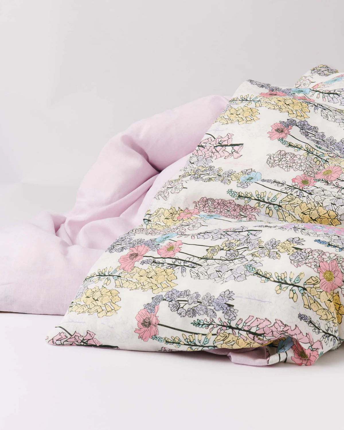 Floral-patterned fabric with lilac material on a light gray background