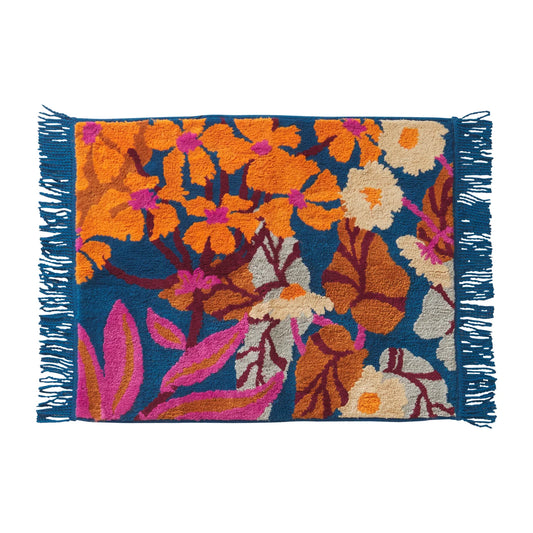 Floral patterned bath mat with orange, pink, and blue colors on a white background
