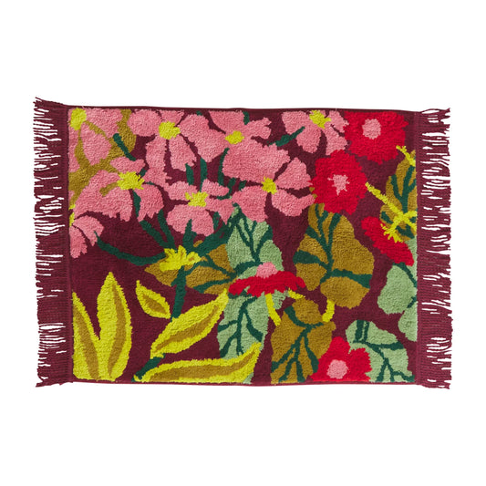 Floral patterned bath mat with pink, red, and green flowers on a maroon background.