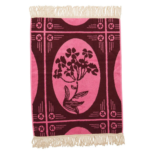Decorative hand towel with floral design and fringe on a white background