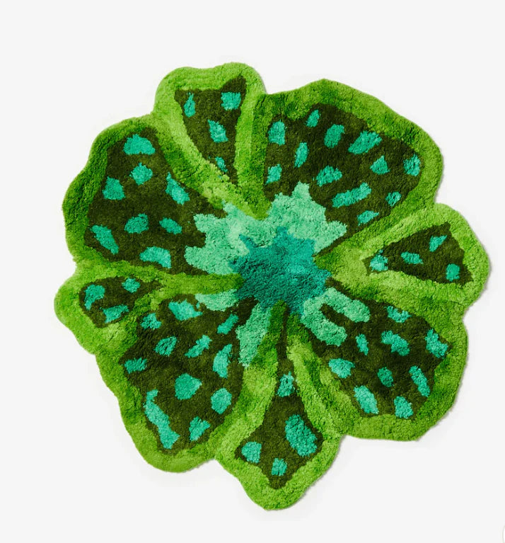 Green and teal floral-patterned rug on a white background