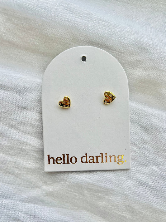Heart-shaped earrings on a 'hello darling' branded card against a white background