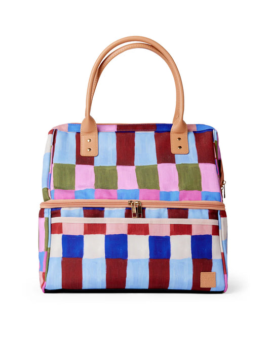 Cooler bag on white background with blue, maroon, green, cream and pink pattern.