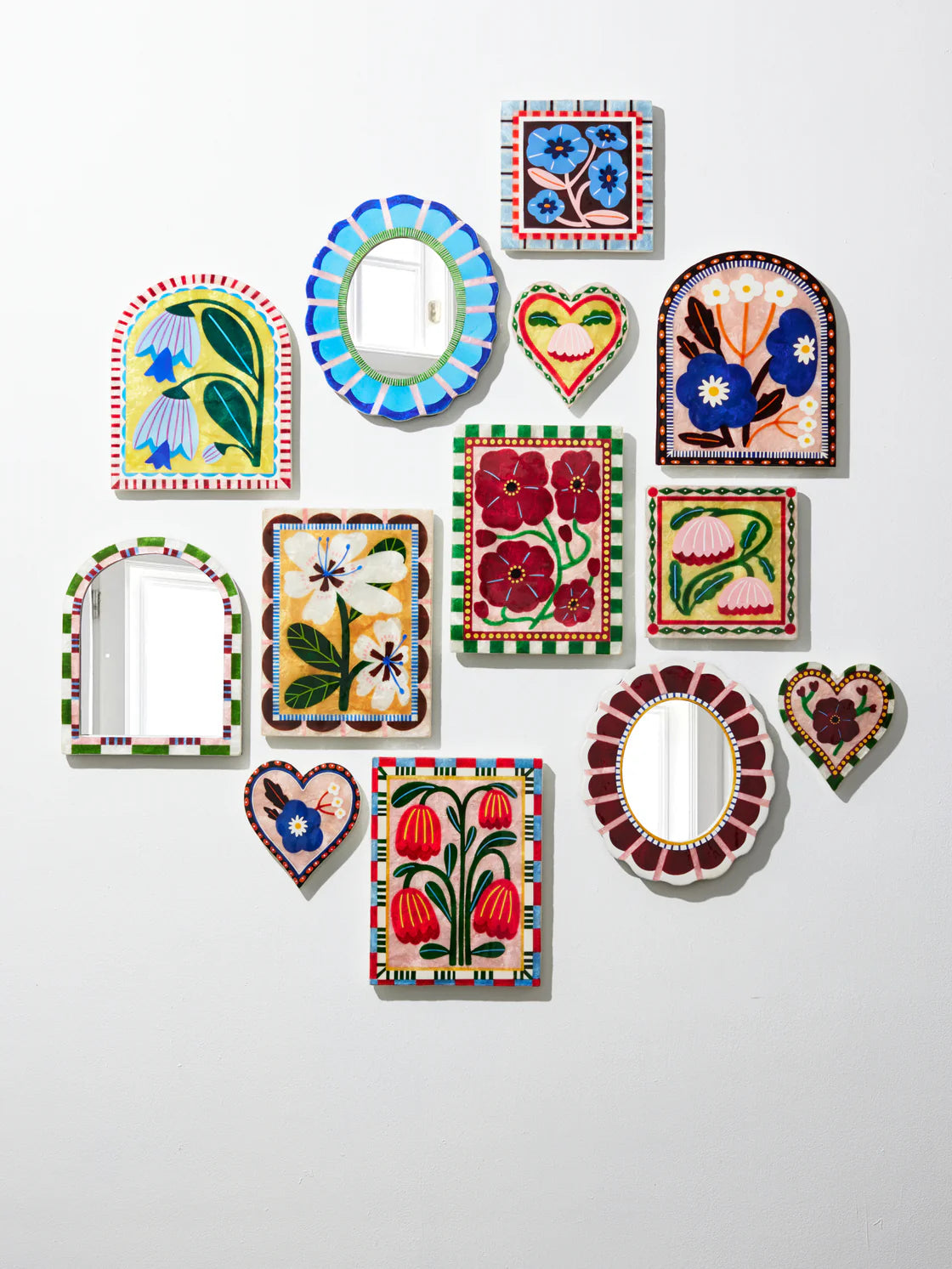 Collection of colorful decorative wall mirrors on a white background