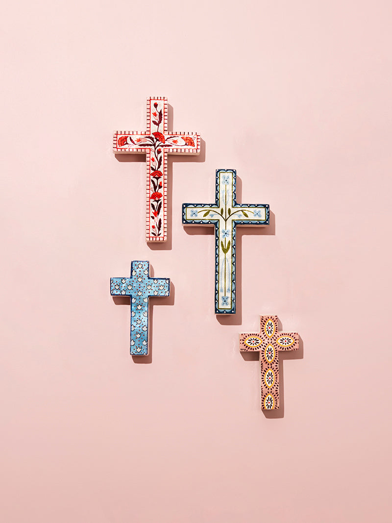 Decorative crosses with intricate patterns on a pink background