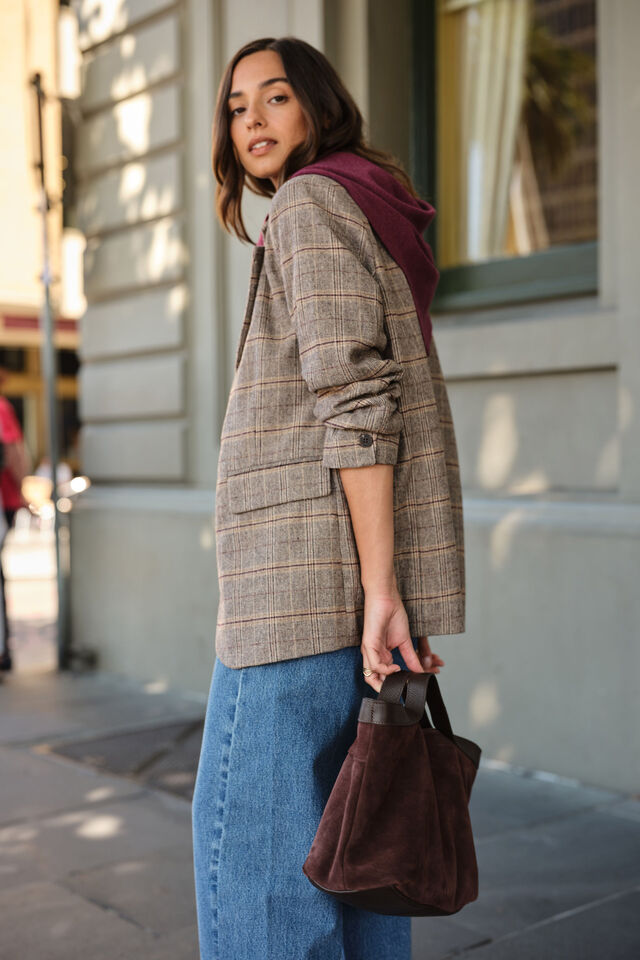 Woman holding a brown bag on a city street