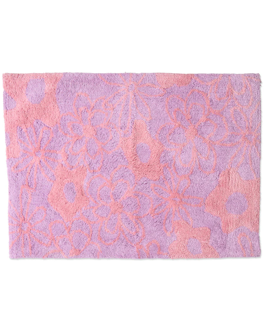 Pink and purple floral patterned bath mat on a white background