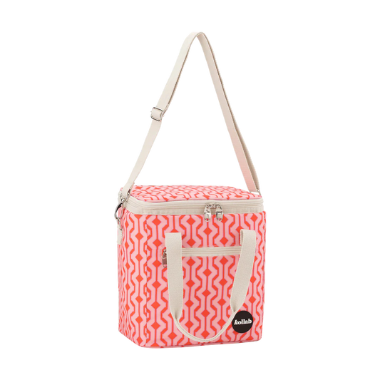 Pink and white patterned cooler bag with a shoulder strap on a white background
