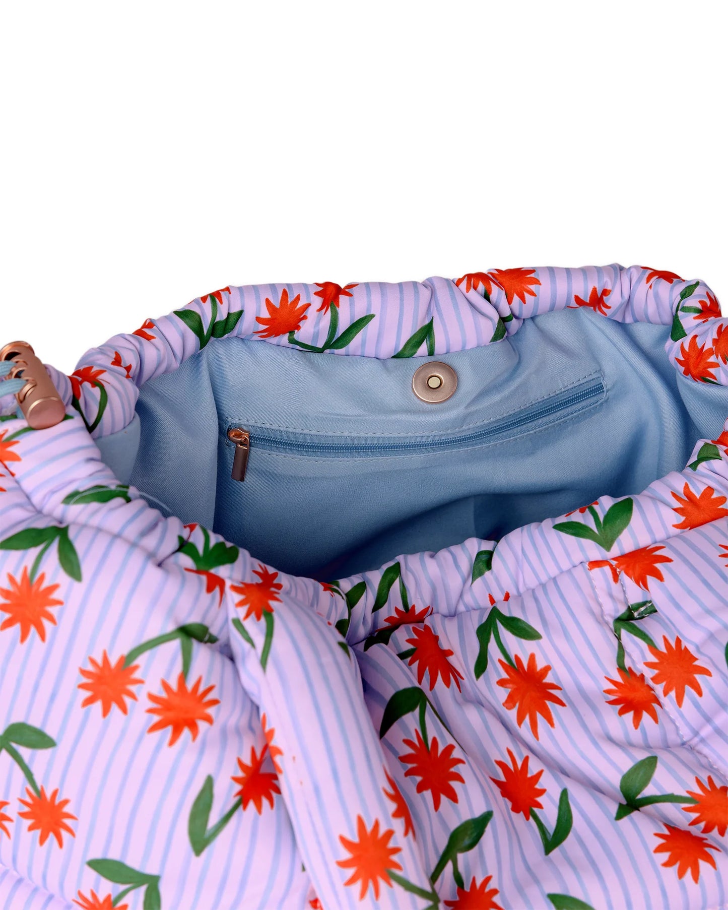 Floral-patterned fabric with a blue interior pocket on a white background
