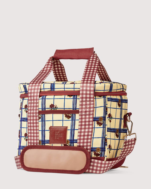 Plaid patterned bag with checkered handles on a light gray background