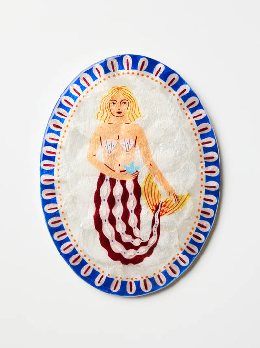 Decorative plate with a mermaid design on a white background