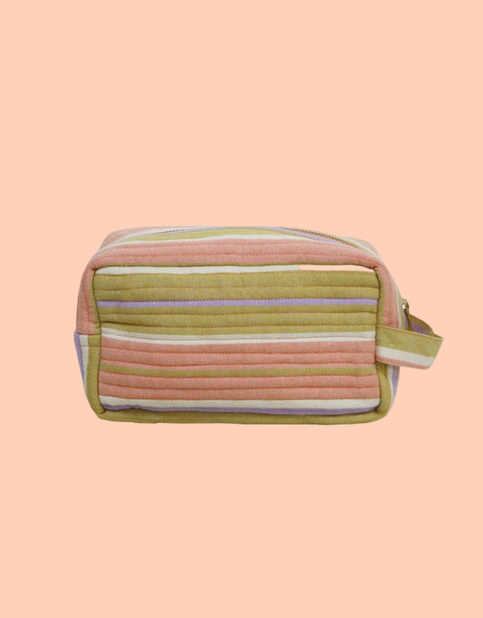 Striped toiletry bag on a light gray background
