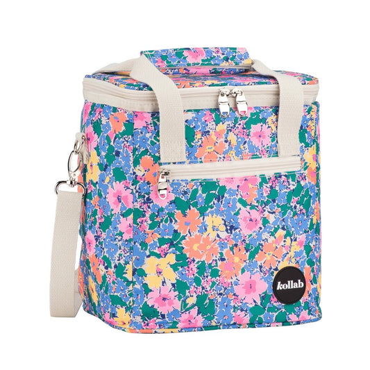 A Kollab insulated cooler bag with a vibrant multicolor floral pattern on a teal background, featuring beige webbed handles and a matching shoulder strap.