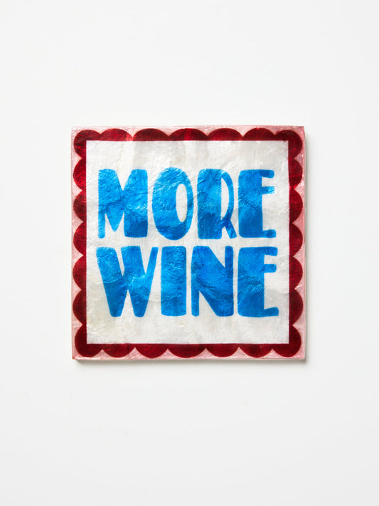 Shell wall tile with 'More Wine' text on a white background