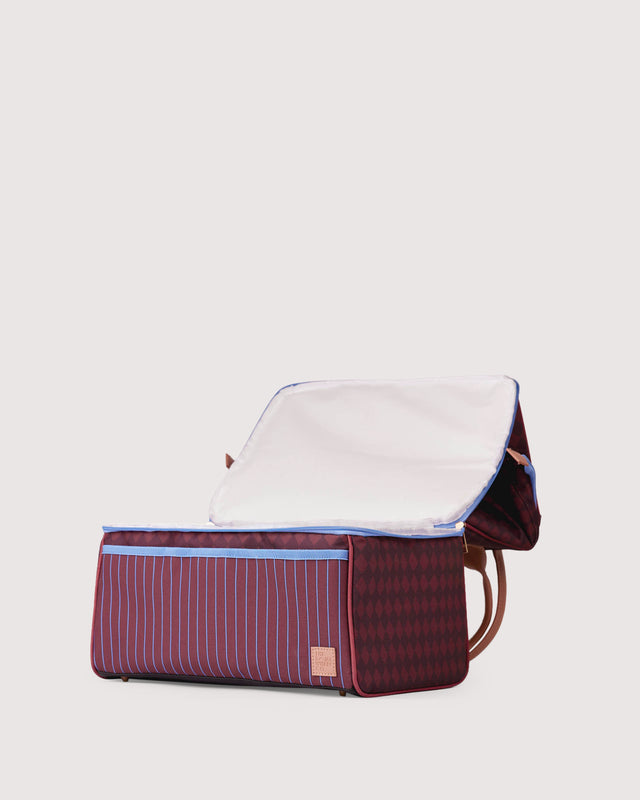 Maroon and white striped bag with a beige interior on a light gray background