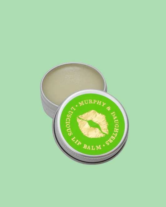 Lip balm in a tin with a green label on a light green background