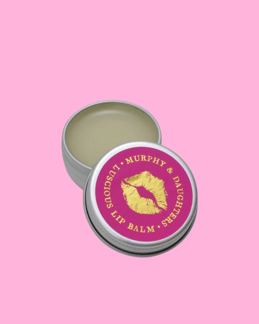Lip balm tin with pink lid featuring 'Murphy & Daughter' branding on a pink background. 