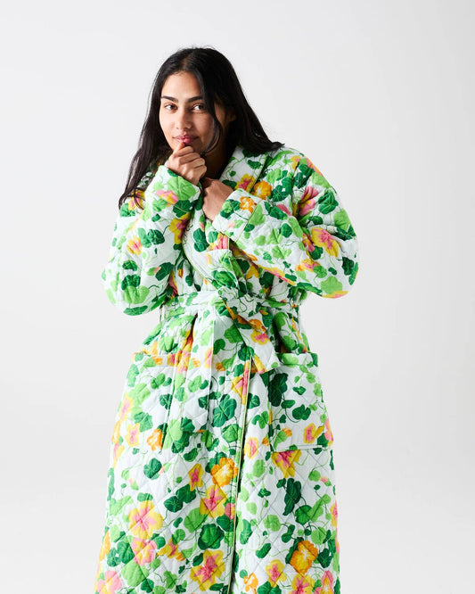 Woman wearing a floral patterned robe on a white background