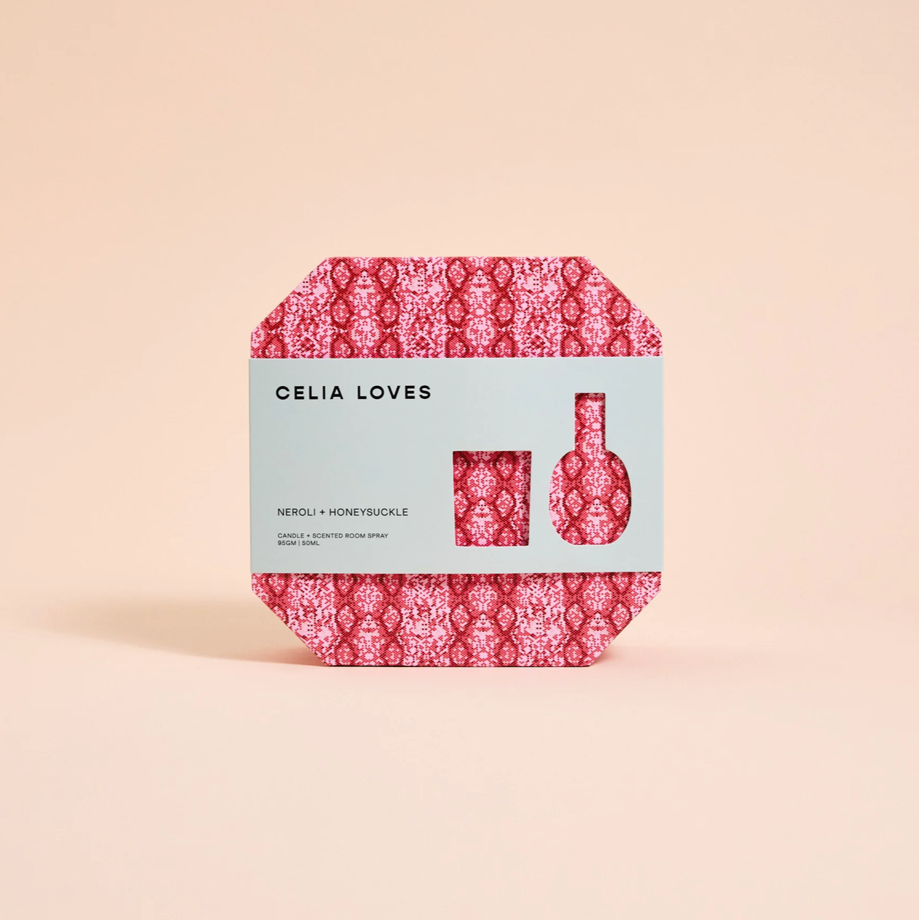 Celia Loves gift pack with red pink pattern on box, green sleeve around box with details of scent and size reference for candle and room spray inside box.