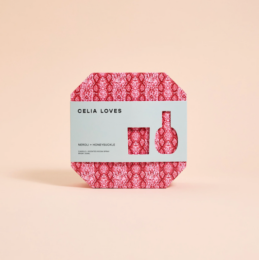 Celia Loves gift pack with red pink pattern on box, green sleeve around box with details of scent and size reference for candle and room spray inside box.