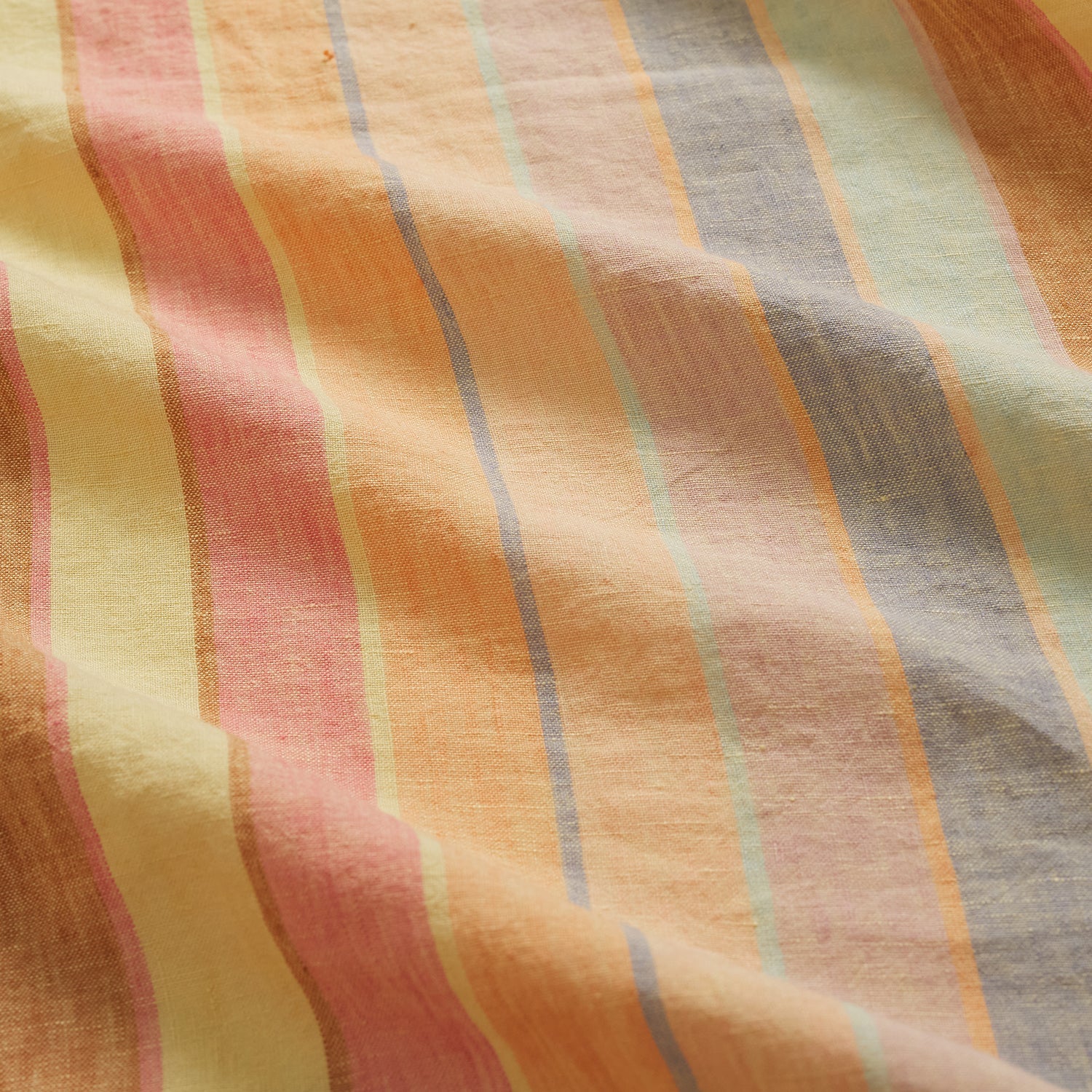 Close-up of striped fabric with warm pastel colors