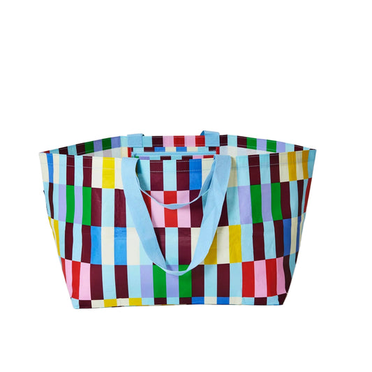 Colorful checkered tote bag with blue handles on a white background