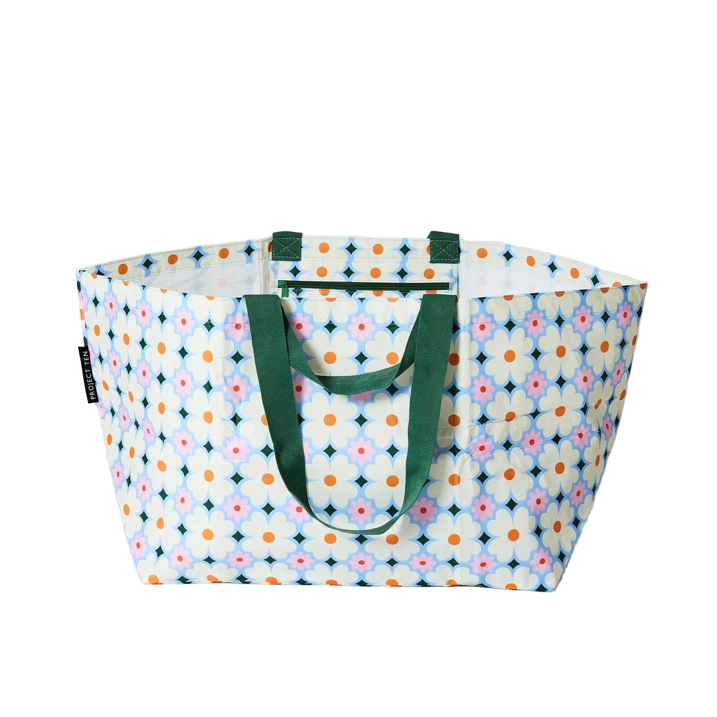 Multicolored patterned tote bag with green handles on a white background
