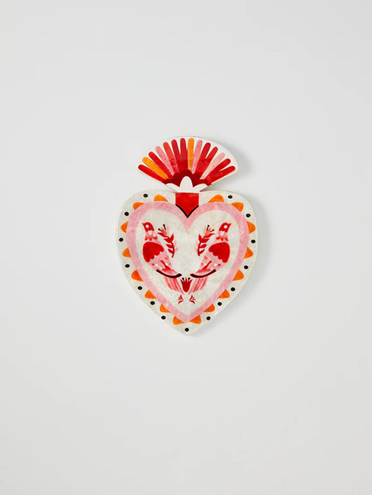 Decorative heart-shaped object with red and orange design on a white background