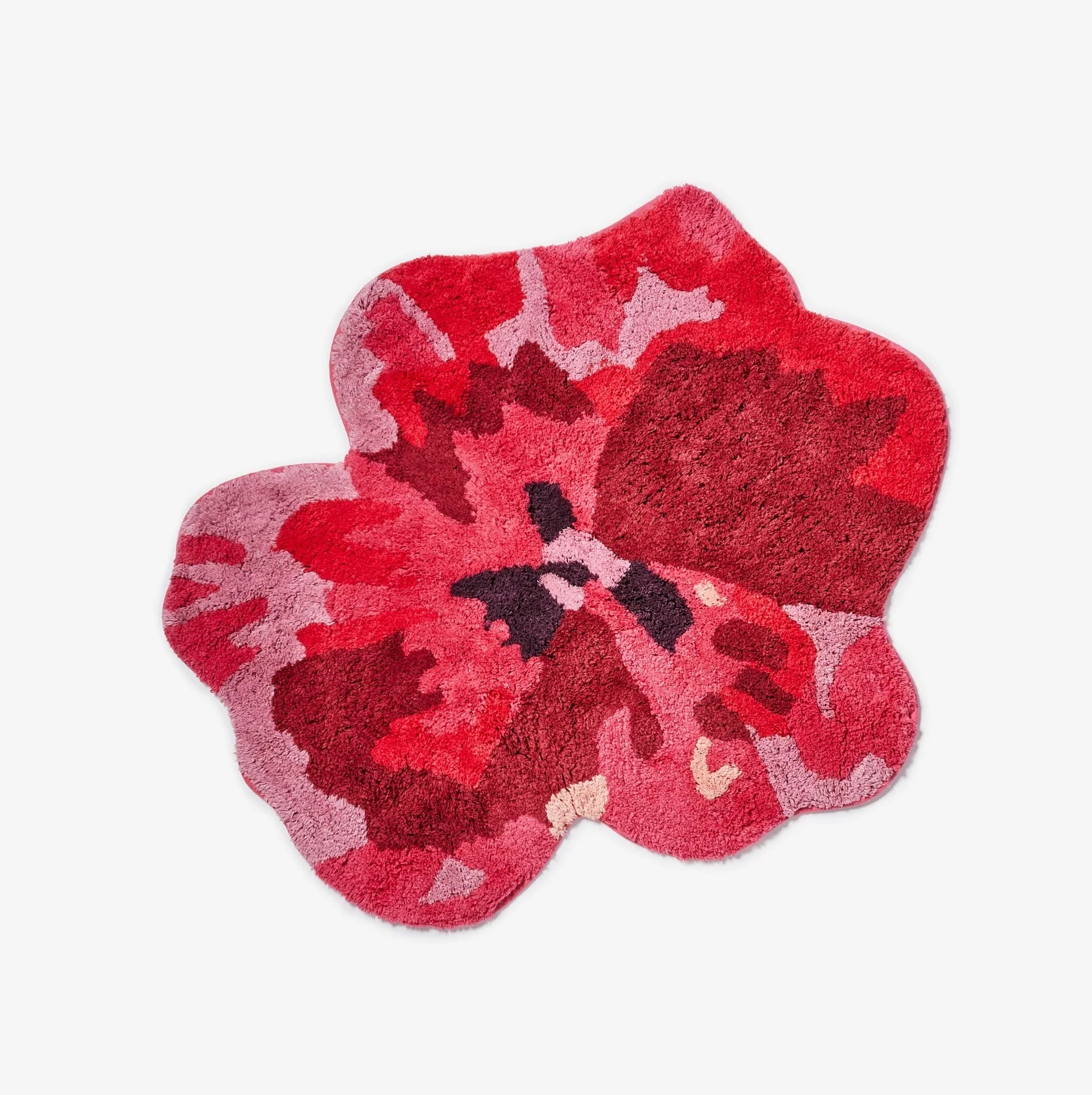 Floral-patterned bath mat with red and pink colors on a white background