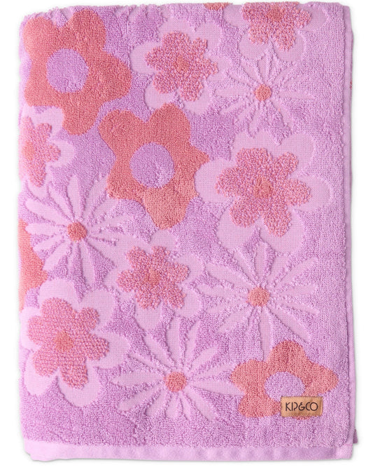 Pink towel with floral patterns and KPCB logo on a white background