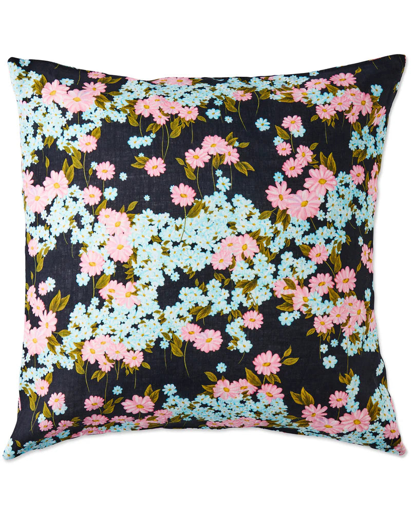 Floral-patterned pillow with pink and blue flowers on a black background.
