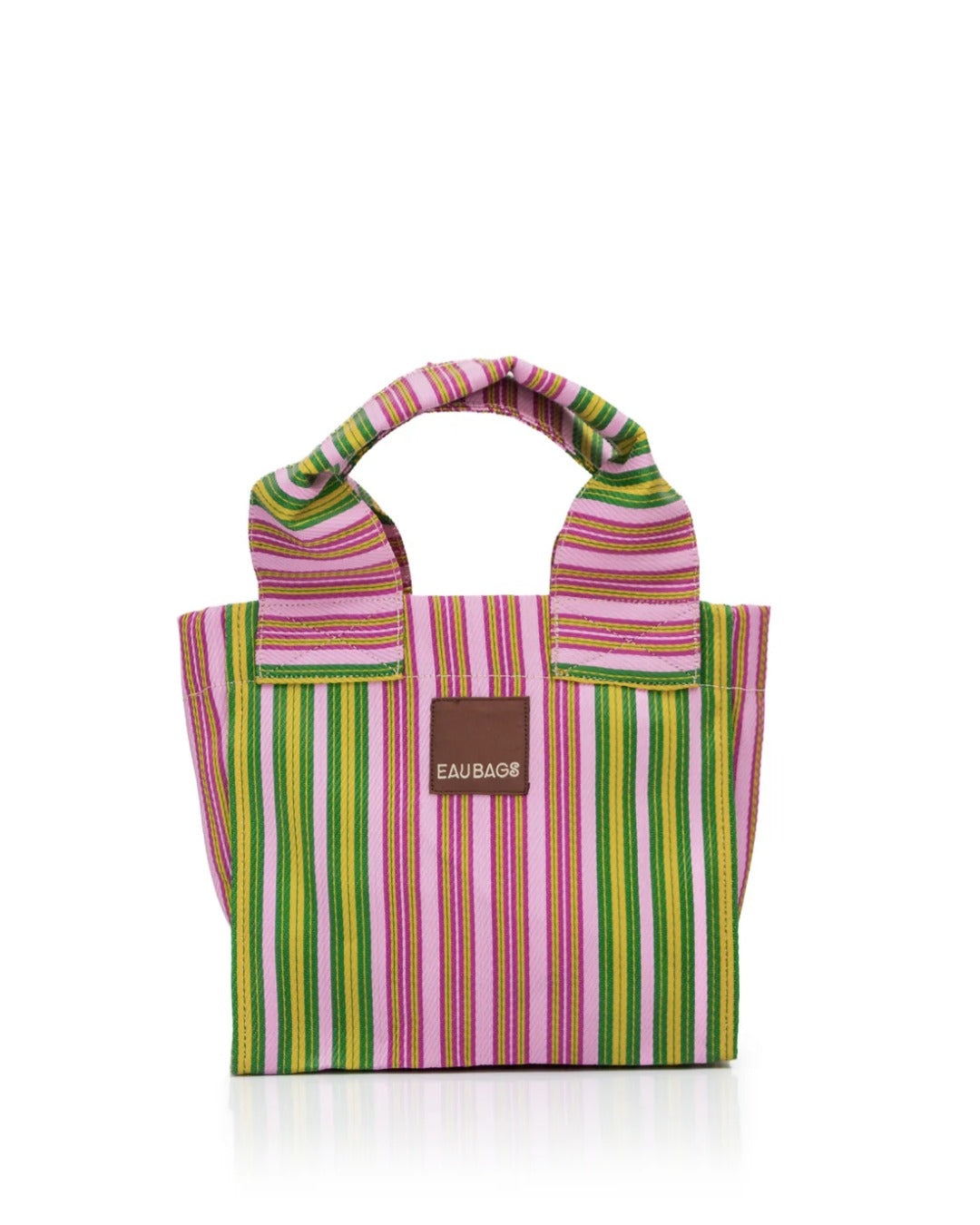 Small bag with double short handles sits with white background, product is a stripe pattern with pink, green and yellow stripes. 'EAU BAGS' logo sits at front of bag. 