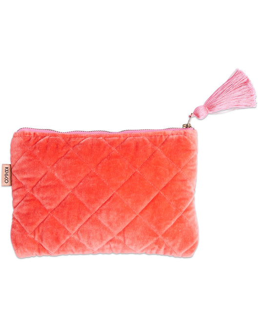 Pink quilted pouch with a tassel on a white background