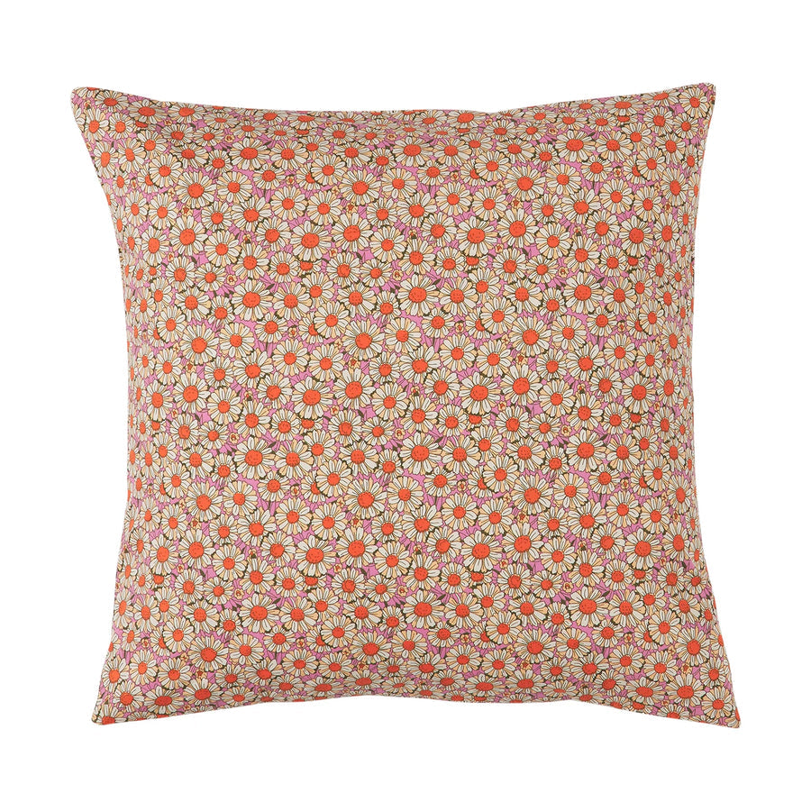 Floral patterned pillow on a pink background