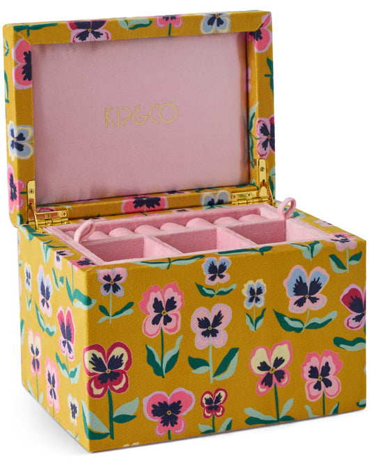 A KIP&CO floral fabric jewelry box with a yellow mustard base, pink interior, and gold-tone hinges, shown open on a white background.