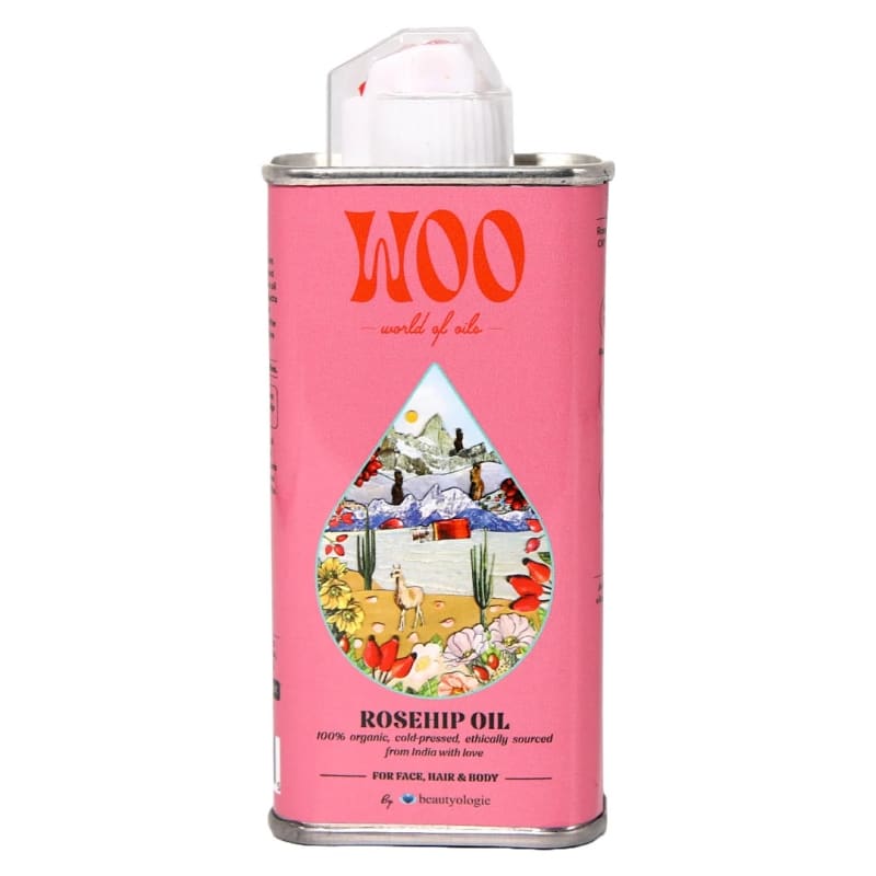 Pink canister of WOO rosehip oil with a colorful label on a white background